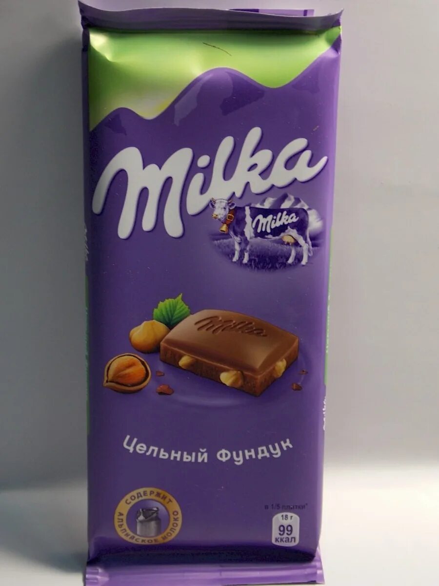 Шоколад Milka молочный с фундуком. Милка молочный шоколад с цельным фундуком. Milka шоколад с цельным фундуком. Шоколадка Милка с цельным фундуком.