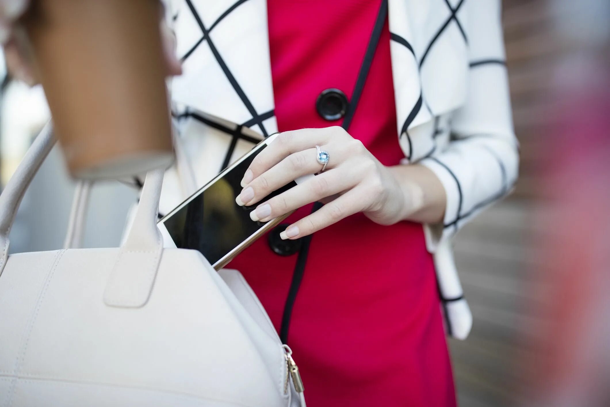 Get something out. Put in a handbag. put something in the bag. put it into bag. put spray in handbag.