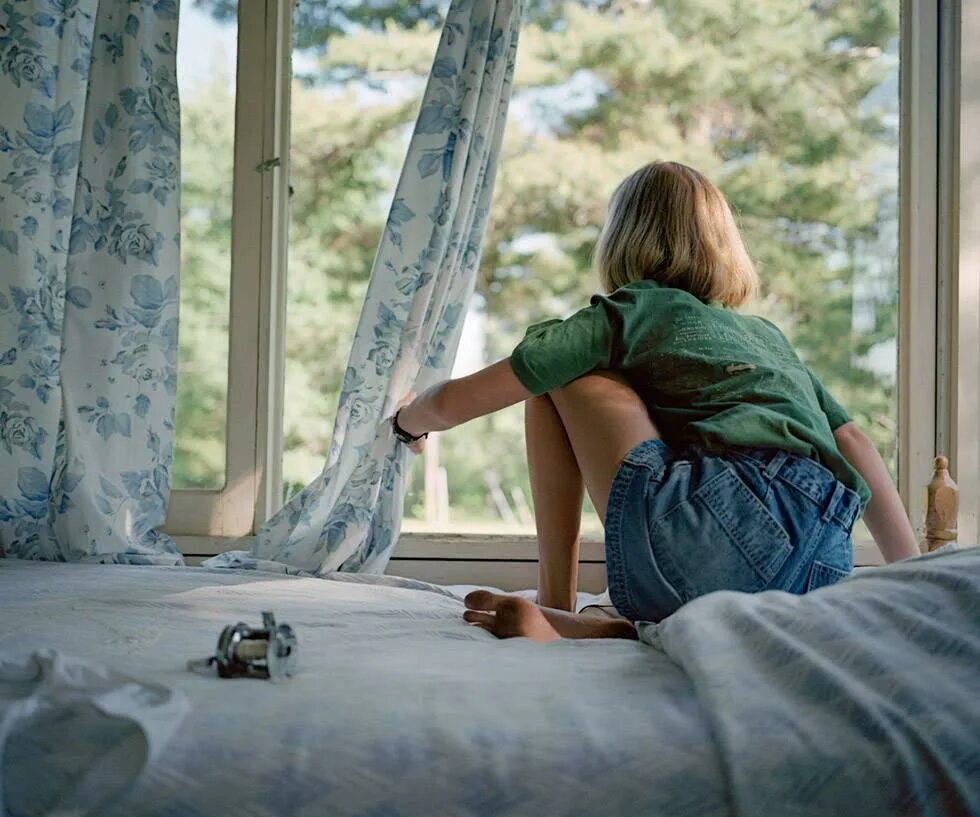 Sally open the window in her room. Looking out of the window. the girl behind the window. girl looking out the window. see out the window.