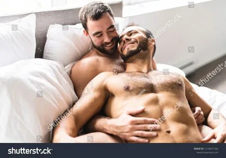 Стоковая фотография: A Handsome gay men couple on bed together. 