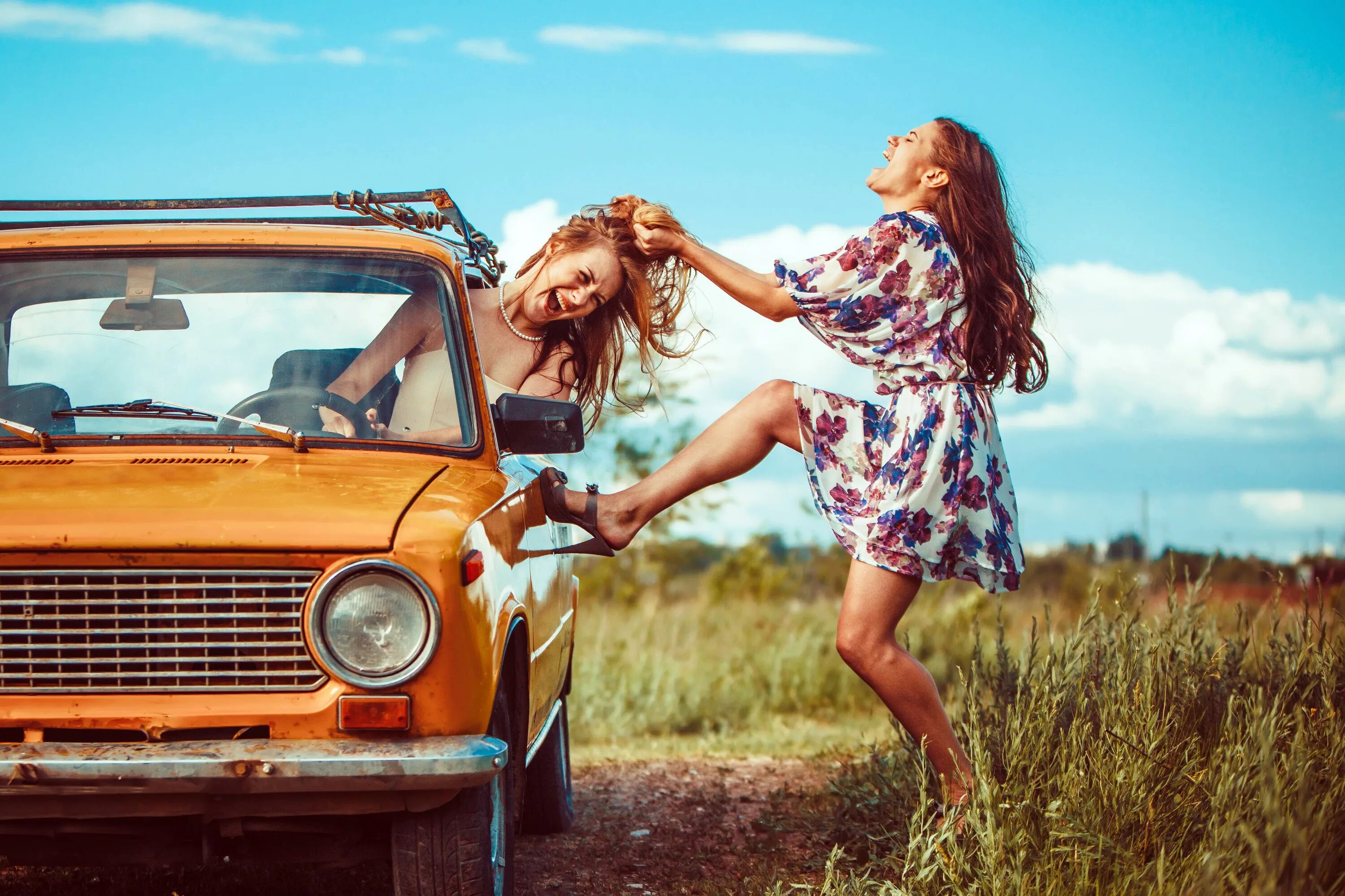 She fixes cars. Girl hitting the car.