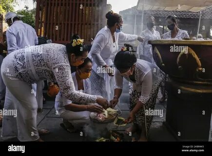 Balinese Hindus wears face mask as they burning negative symbols during the...