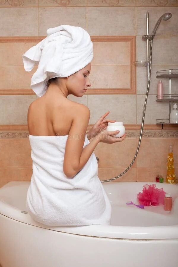 In the Bathroom. Woman in White Towel in Head Have Care of Herself Stock Photo -