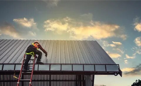 Roof repair team working on residential roof