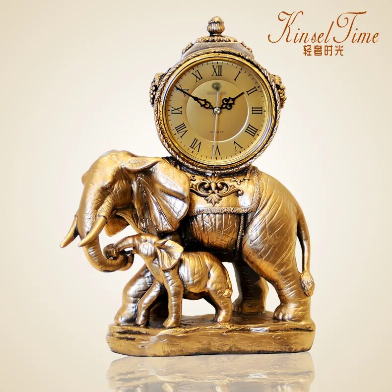 часы настольные со слонами. часы настольные слон со слоненком. сувенир часы настольные с клыками слона. часы со слоником будильник. часы со слоном.