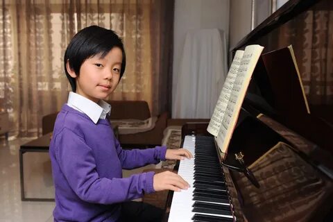 Boy playing piano - Revolution Arts.