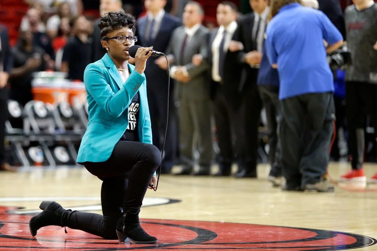 During the performance. Black lives matter miami heat. u.s. national anthem kneeling protests. people singing the national anthem.