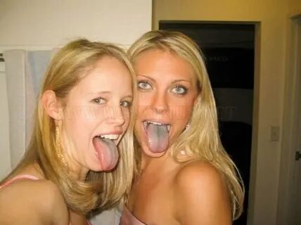 Studio Portrait Of Cute Teen Girls Sticking Out Tongue by Stocksy