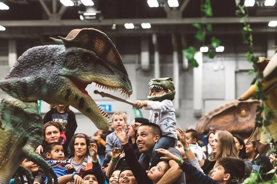 Смешной костюм динозавра. Мужик в костюме динозавра. Костюмы в виде динозавров реалистичные. Толпа в костюмах динозавров. Костюм три динозавра.