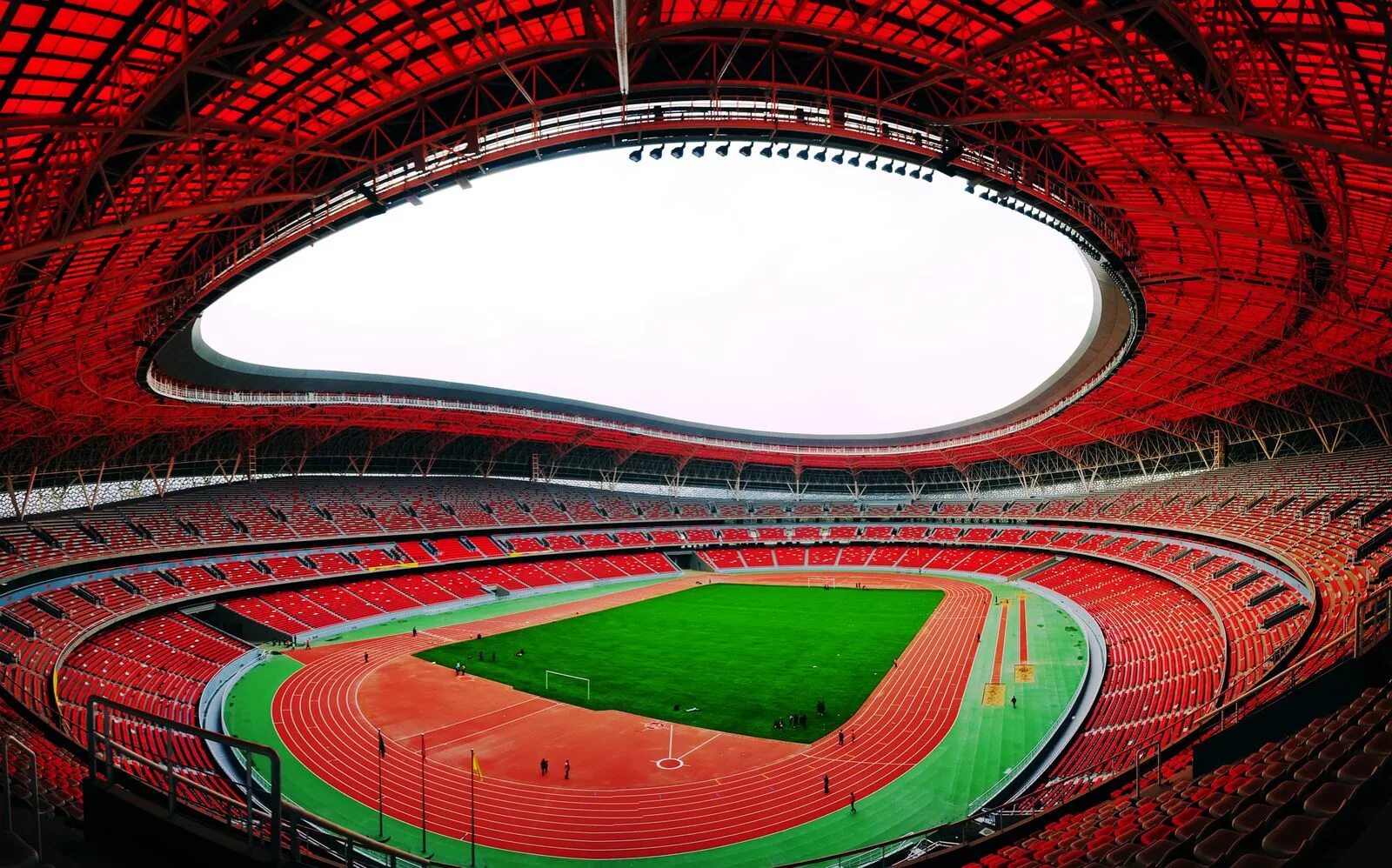 Стадионы китая. Стадион в Чунцине. «Dalian» стадион в Китае. Ордос Стэдиум Китай. Олимпийский стадион Ееги.