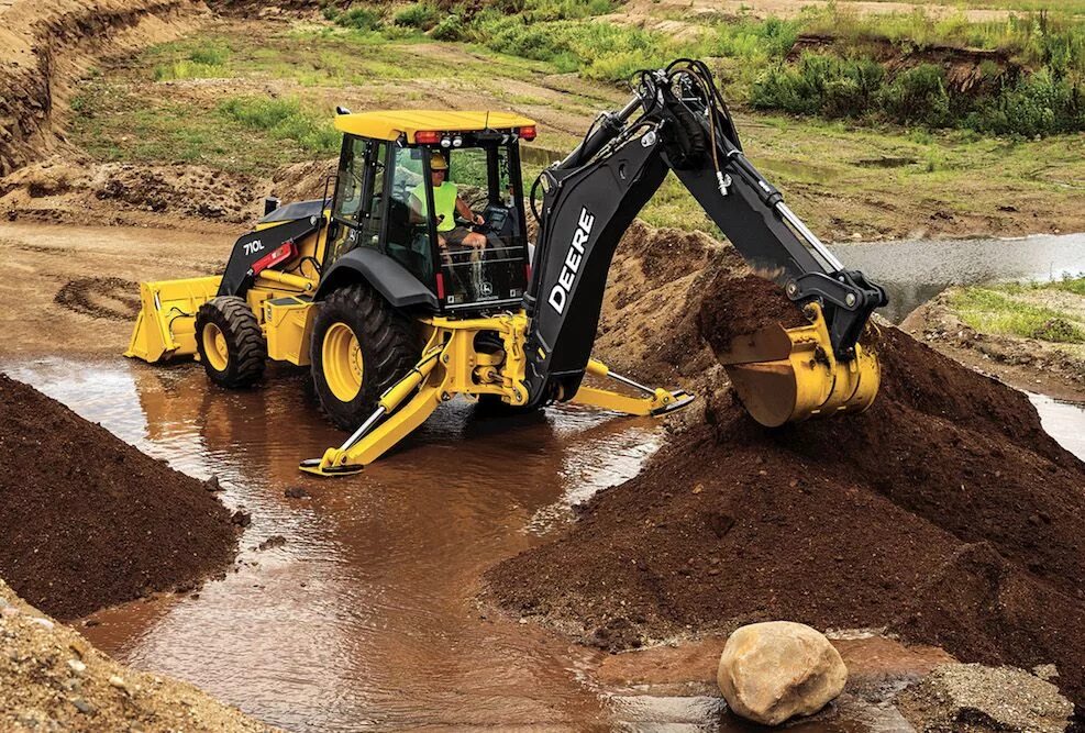 Эксковатора или экскаватор. John Deere 710l Backhoe. Экскаватор-погрузчик John Deere 325к. John Deere 710. John Deere погрузчик.