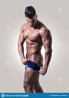 Muscular Man Pulling Down Underwear In Studio Stock Image - Image of pantie...