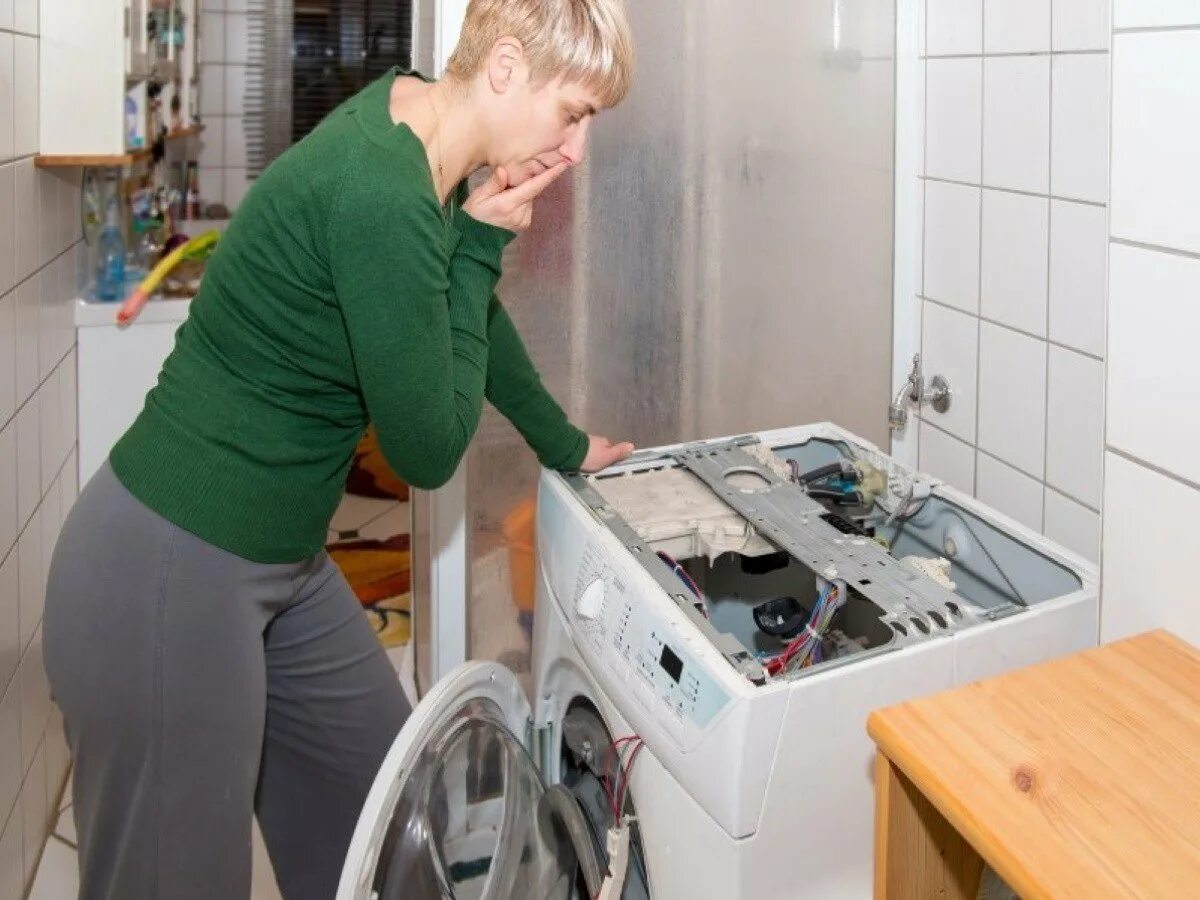Утилизация стиральных машин. Женщина стирает. Стиральная машина протекает. Отстирала вещи в стиральной машине.