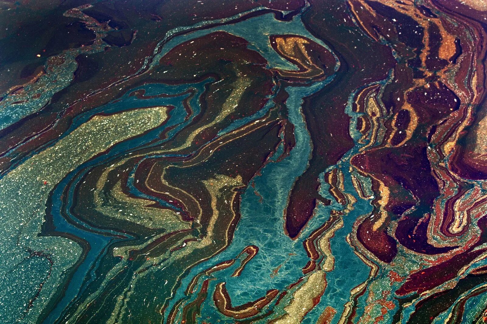Масляная пленка на воде. Нефтяное пятно. нефтяные пятна на воде. нефтяная пленка на воде. нефтяная пленка в океане.