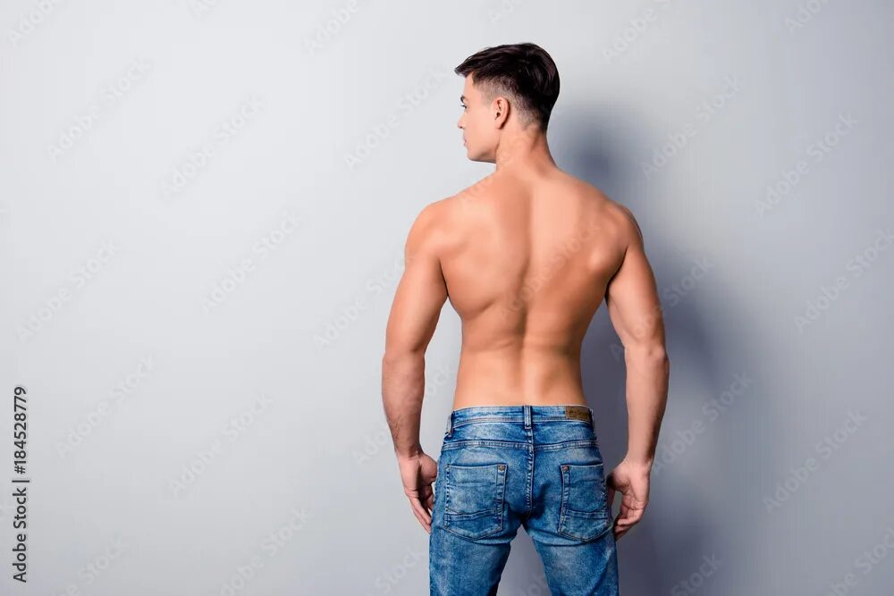 Male model back. He is wearing jeans