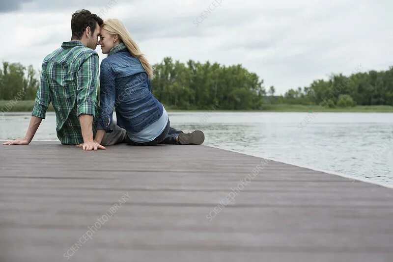 Sitting closer. Woman and man Lake. Man on Jetty Lake back view. Romantic Jetty Lake man. Man standing on Jetty Romantic.