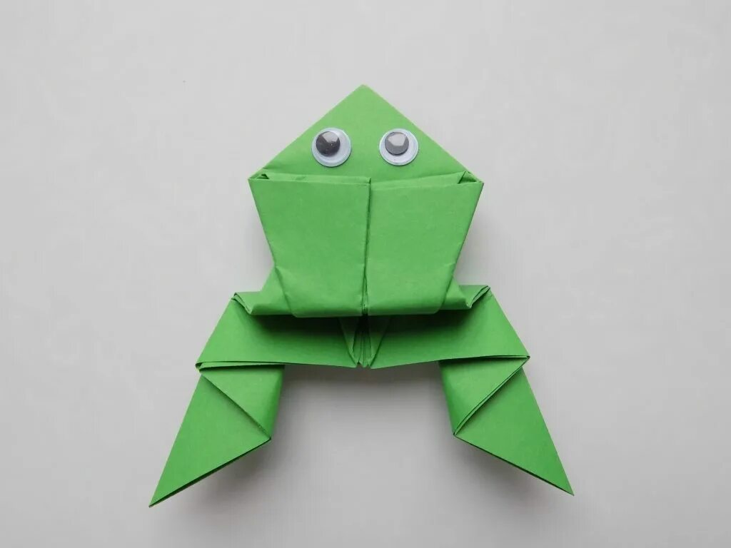 Бумажные поделки самоделки. Оригами Царевна лягушка. Лягушка попрыгушка оригами. Лягушка оригами из бумаги 1 класс. Оригами из бумаги для детей лягушка попрыгушка.