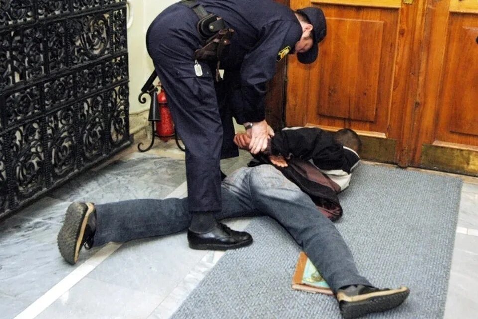 Полицейский скручивает преступника. Полицейский с пористунрком.