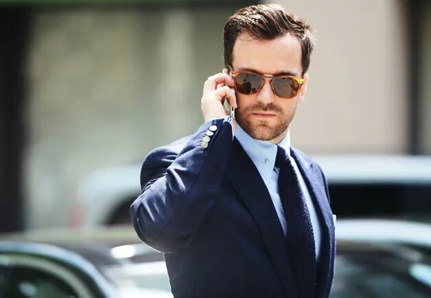 Man in Suit Standing Next to Car