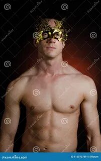 Photo about Carnival. naked man in a gold mask. 
