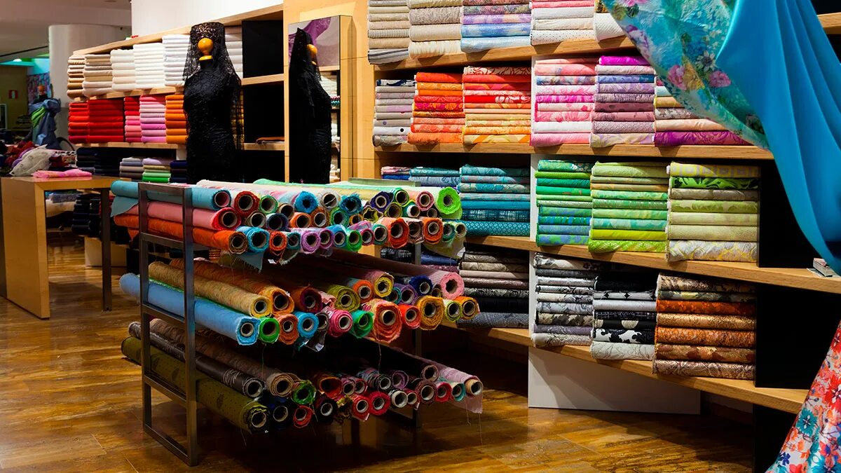 Магазин тканей. Оптовая торговля текстильными изделиями. Материалы для шитья одежды. Рулон ткани. Ассортимент тканей.