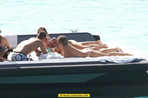 Tania Cagnotto sunbathing topless on a boat.