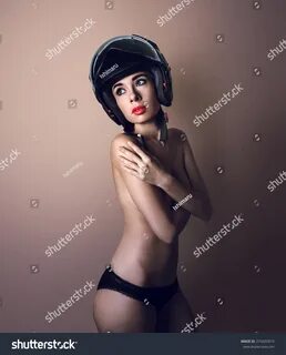 Naked Girl motorcycle rider in a black helmet with red lips and black under...