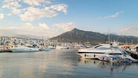 Puerto Banus Marina which includes a sunset and a bay or harbour.