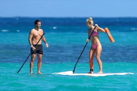 Vogue Williams in Pink Bikini Paddleboarding at a beach in St. Barth. 