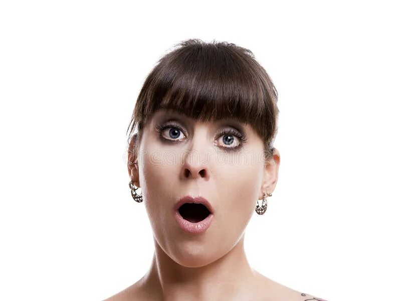 Девочка показывает язык. Удивлена как пишется. Широко раскрытые удивленные глаза. Пальцем открывает рот. Удивленная девушка.