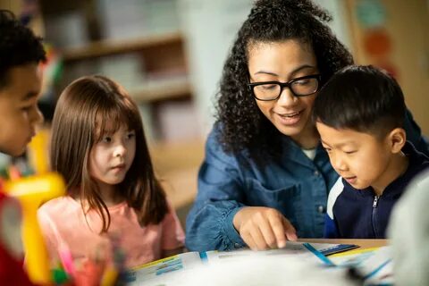 A teacher reading with some young learners. 