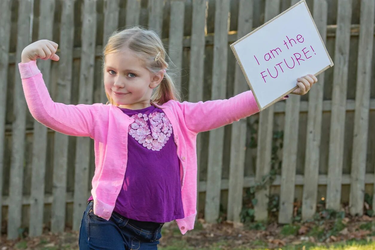 Девочка хочет помогать. Девочка проведение. The child holds the sign. School age girl. Girl holding sign.