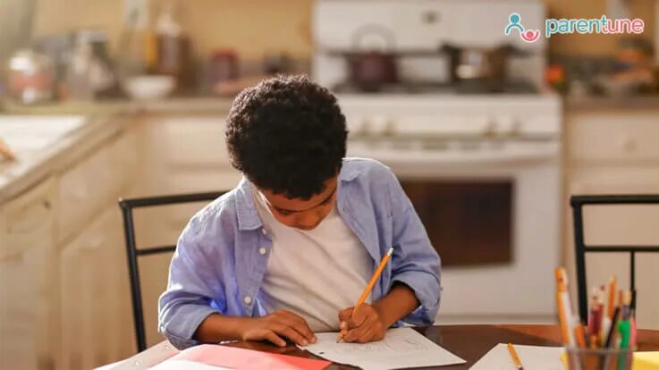 She is sitting at the table. Writing skills. Do homework. Фото writing stories. In writing.