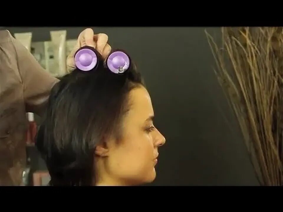 Electric hot Curler for long hair. Hairstyle with a Roller over the forehead.