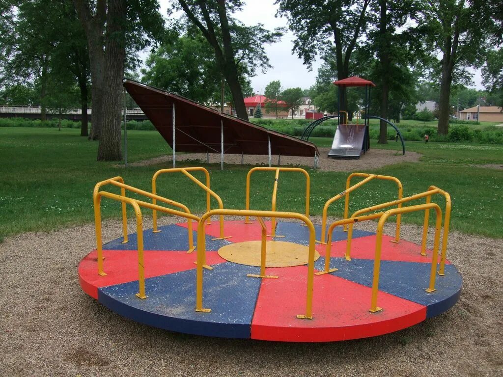 Long playground. Roundabout playground. merry go round on the playground. roundabout kids. roundabout at the playground.