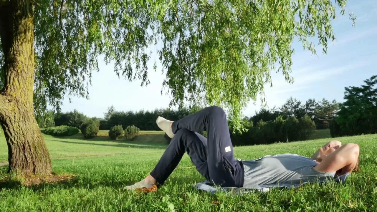 Under the tree. Tom lying under the tree. lying on th ground under tree.