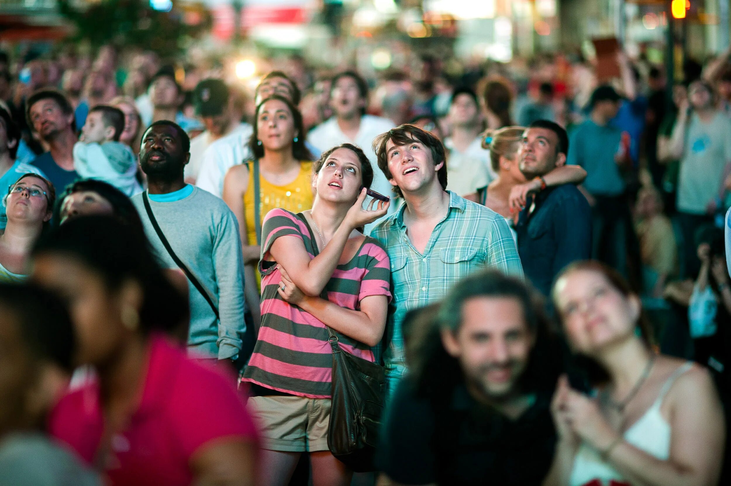 People looking up. Upset people. People on big Screens. People are looking up.