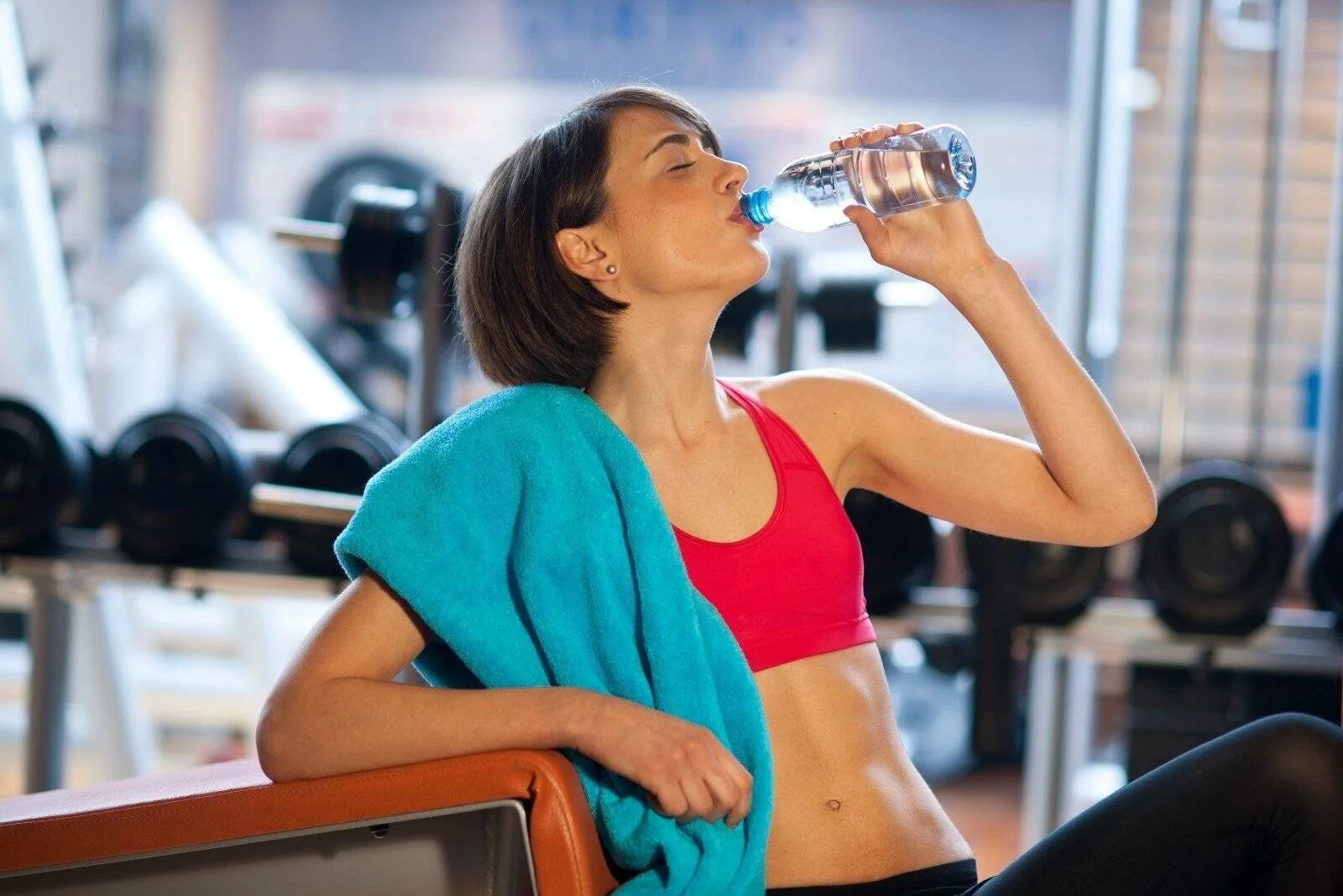 Ли водой после. Девушка пьет воду в спортзале. Девушка в тренажерке пьет воду. Вода в тренажерном зале. Спортсмен пьет воду.