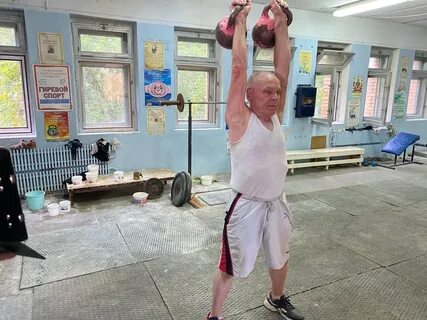 Спортсмен поднимает гирю массой 12 кг