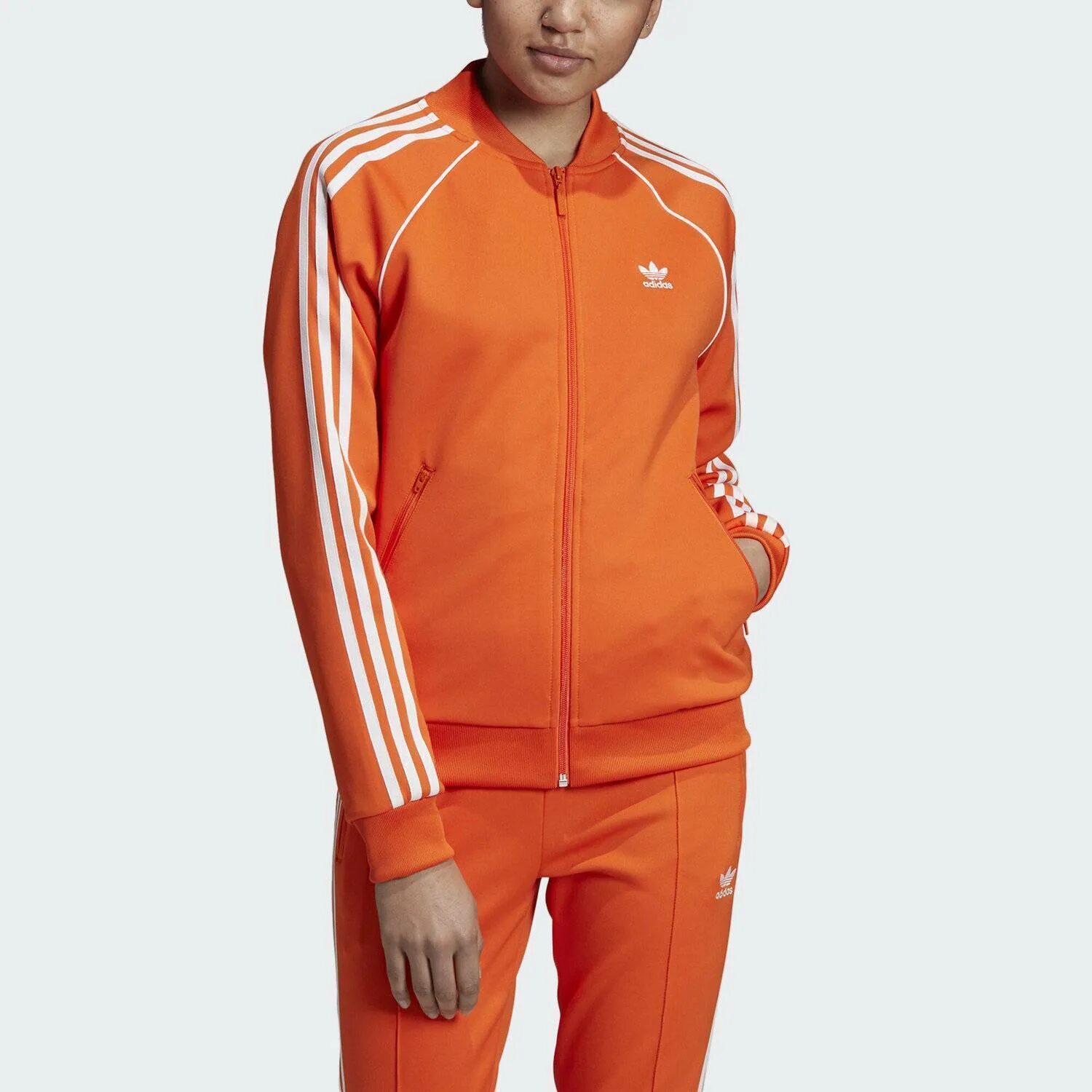 Костюмы адидас оригинал женские. Adidas SST олимпийка мужская оранжевая. Адидас ориджинал оранжевая олимпийка adidas Originals. Костюм адидас SST оранжевый. Оранжевая олимпийка адидас женская ориджинал.