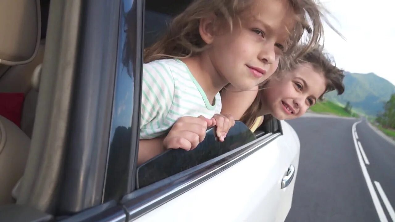 The car is slow. Lean out of the car Window. Kids nose and the car Window. Lean out of the Window of a car pictures for Kids. Carefree childhood.