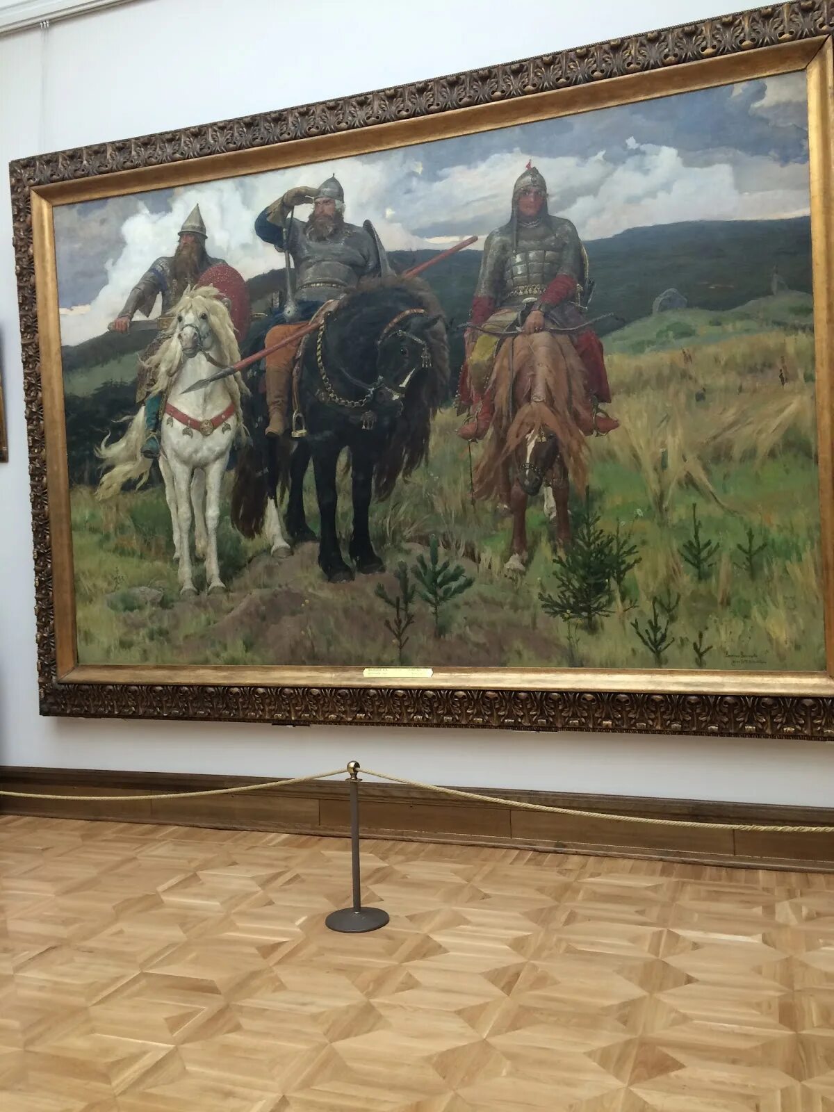 Картина 3 4. Васнецов богатыри Третьяковская галерея. Васнецов картины в Третьяковской галерее. Васнецов три богатыря картина в Третьяковке. Картина богатыри в Третьяковской галерее.