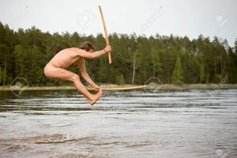 nude man with two wooden samurai swords jumps in water - 3941675 