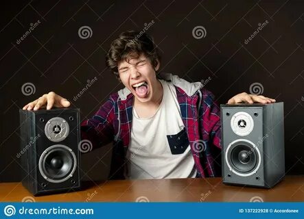 Young Man Audiophile Listen To Loud Music from Speakers F Stock Photo gamba...