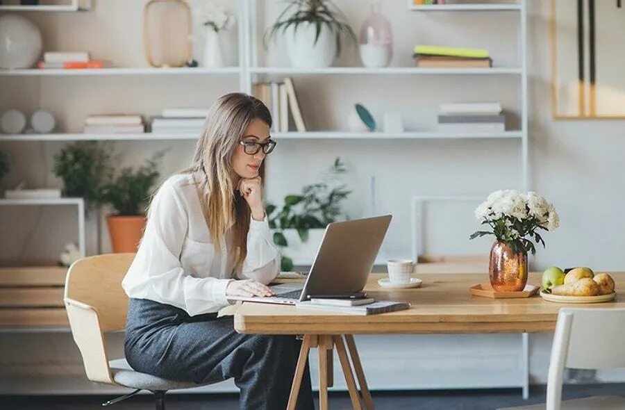 She is sitting at the table. Sitting on the Desk. Sitting at the Desk. Sit a a Desk. Woman in Office.