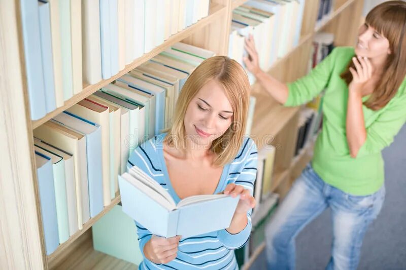 Читать книгу владеющий. Две женщины книга. выбирает книгу. девушка возле полки с книгами. девушка в библиотеке берет книгу с полки.