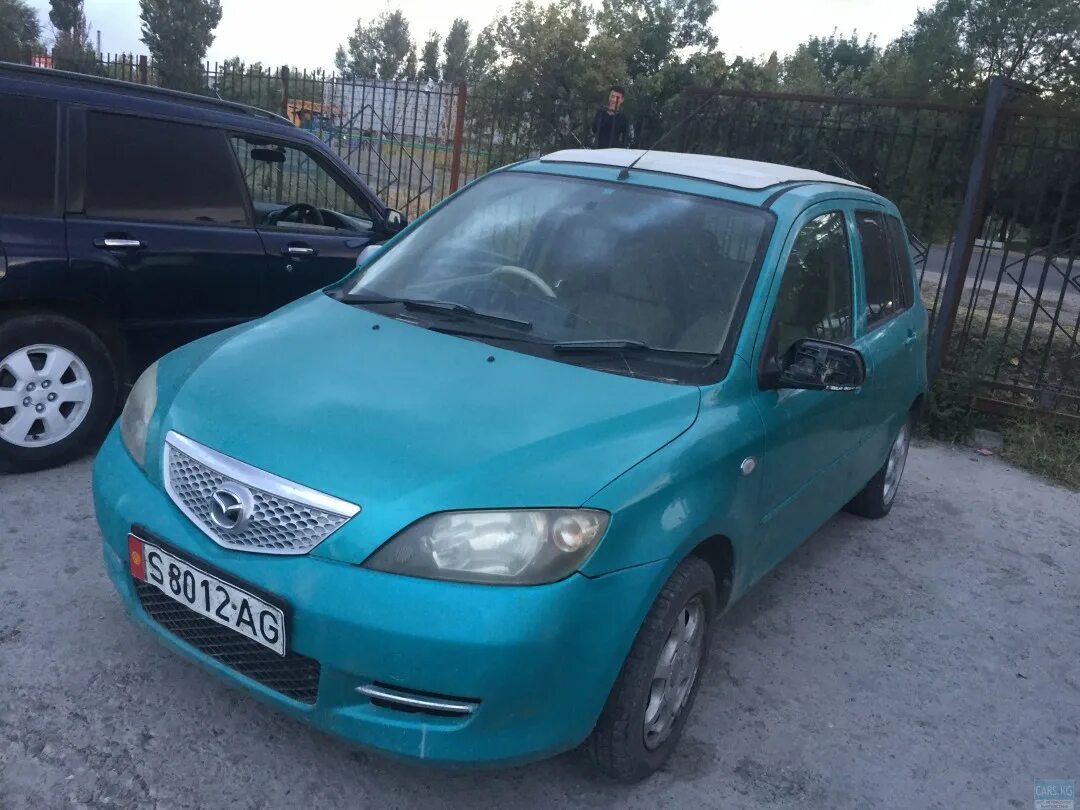 Mazda demio 2. Мазда Демио 2 поколение 2003 года. Мазда Демио 2 кузов. Мазда Демио 2003 цвет бирюзовый.