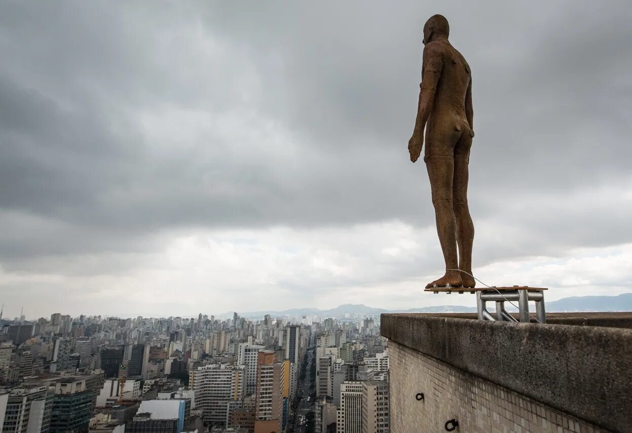 Человек стоит над городом. Энтони Гормли скульптуры. Энтони Гормли Горизонт событий. Статуя в Сан Пауло. Энтони Гормли поле.