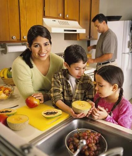 The children are making something to eat. Family eating. make lunch. food preparation. hot summer meal.