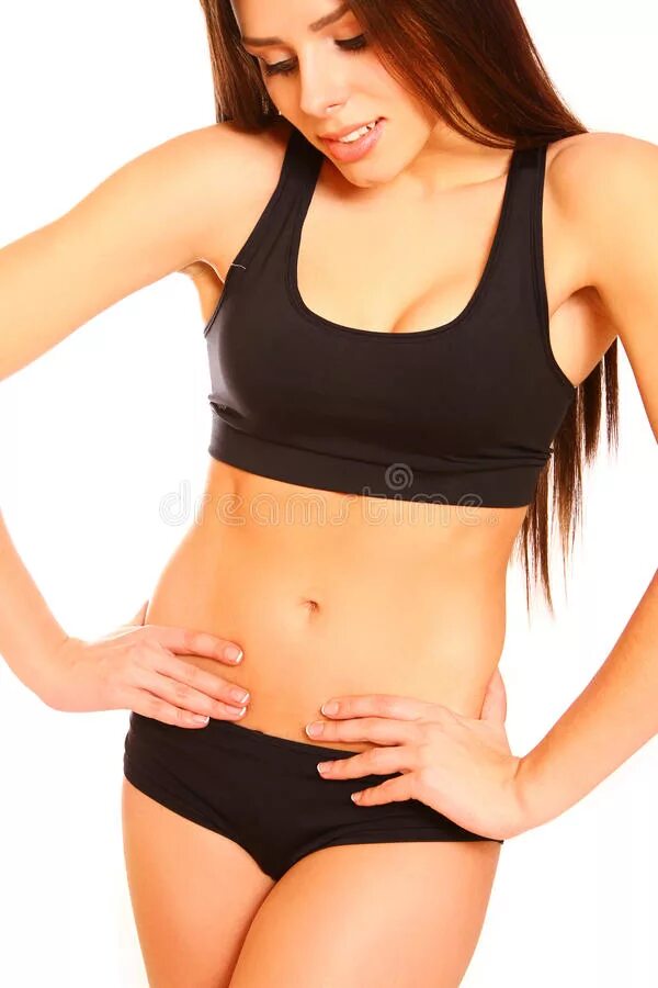 Девушке смотрят живот. Свой живот. Плоский животик. Женщина держится за живот. Девушка недовольна своим телом.